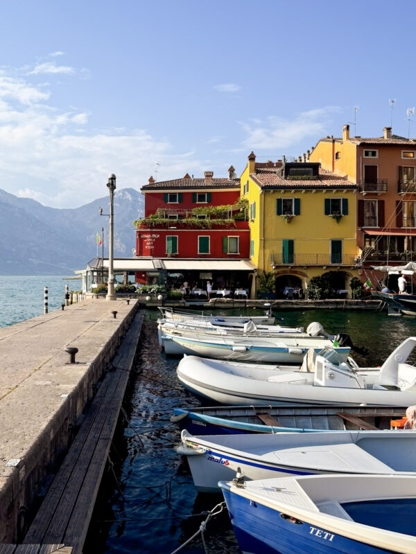 Boats docked at the colorful Portiocciolo di Malcesine, Lake Garda, Italy